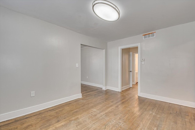 spare room with light hardwood / wood-style flooring