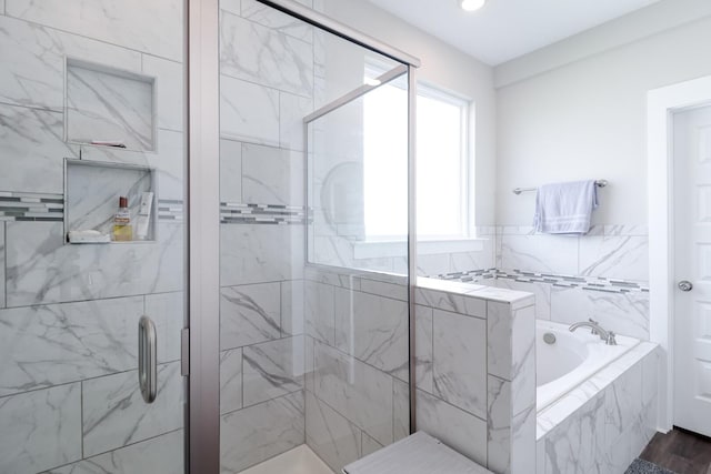 bathroom featuring a stall shower, a garden tub, and recessed lighting