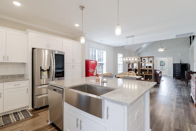 kitchen with decorative light fixtures, a sink, appliances with stainless steel finishes, white cabinetry, and ceiling fan with notable chandelier