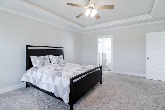 carpeted bedroom featuring baseboards, a tray ceiling, and ornamental molding