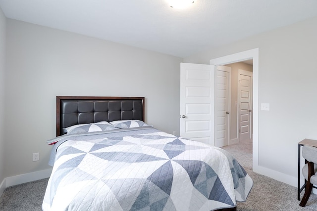 bedroom featuring carpet flooring and baseboards