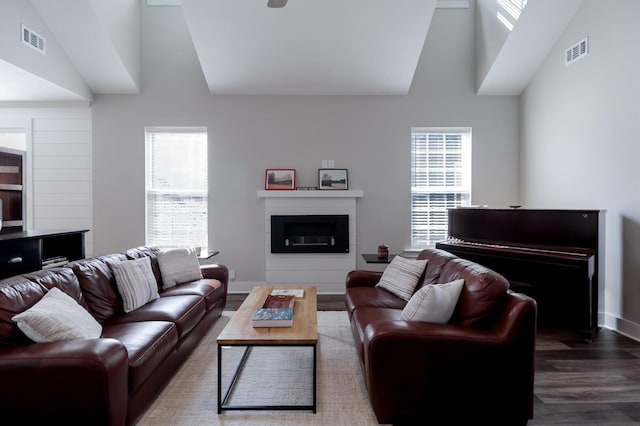 living room with a healthy amount of sunlight, visible vents, and wood finished floors