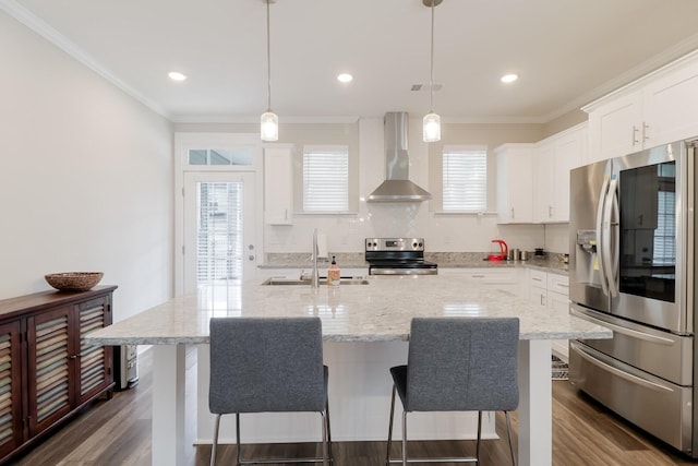 kitchen featuring a sink, tasteful backsplash, wall chimney exhaust hood, and stainless steel appliances