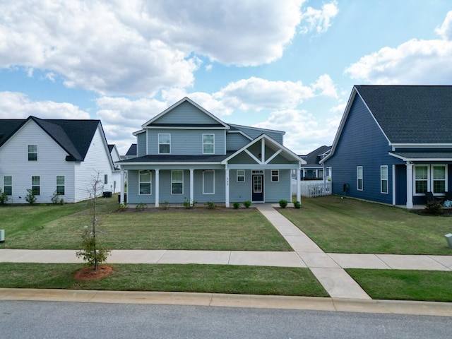 view of front of home with covered porch and a front yard