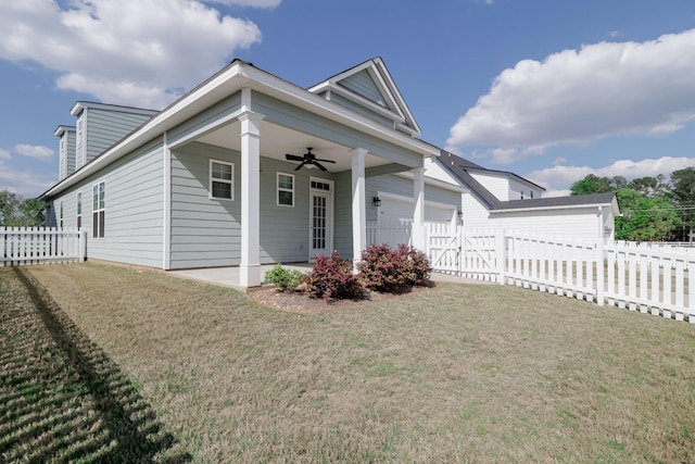 view of front facade featuring a patio, a front lawn, a fenced backyard, ceiling fan, and a garage