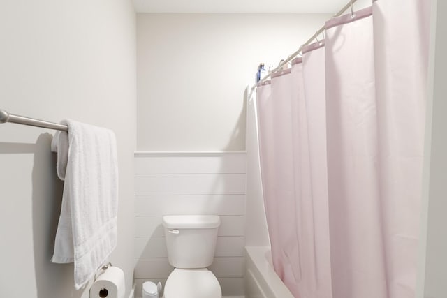full bathroom with toilet and shower / bath combination with curtain