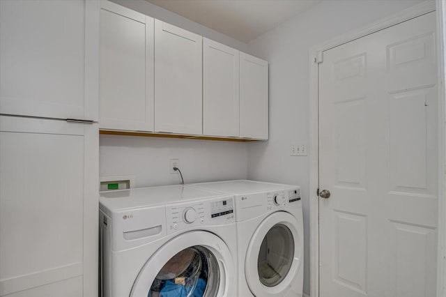 washroom with cabinet space and independent washer and dryer