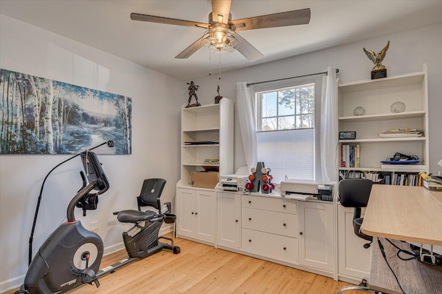 workout room featuring ceiling fan, light wood finished floors, and baseboards