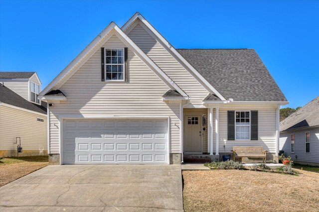 traditional home featuring a garage, concrete driveway, and roof with shingles