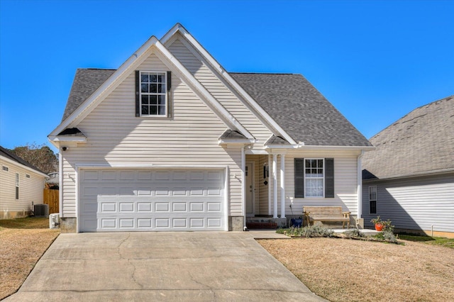 traditional-style house featuring central air condition unit, driveway, and roof with shingles