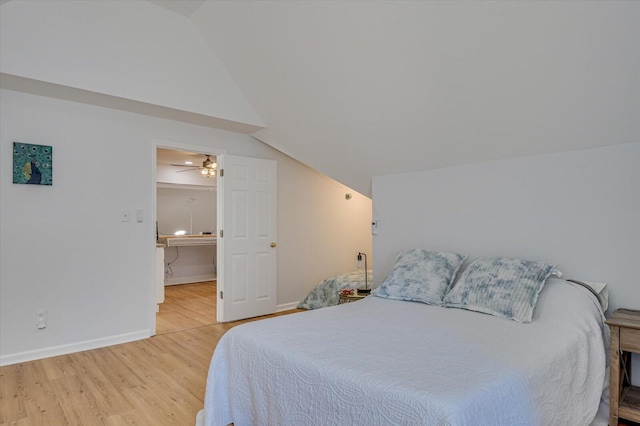 bedroom featuring light wood-style floors, vaulted ceiling, and baseboards