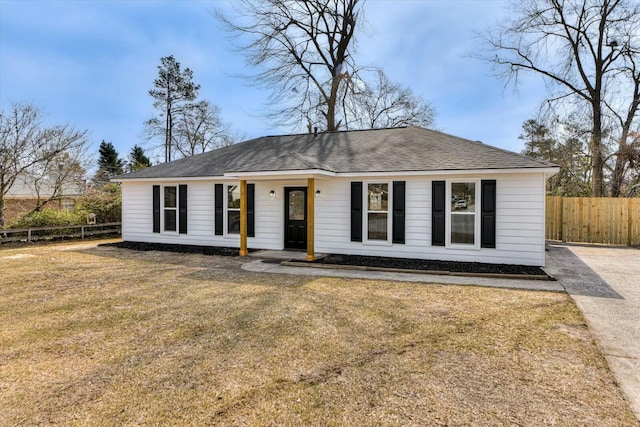 single story home with a front yard and fence