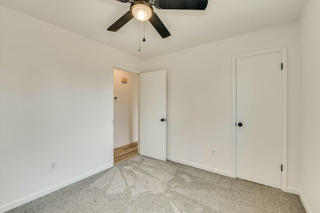 unfurnished bedroom with carpet flooring, ceiling fan, and baseboards