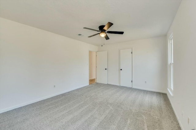 unfurnished bedroom featuring visible vents, baseboards, carpet, and ceiling fan