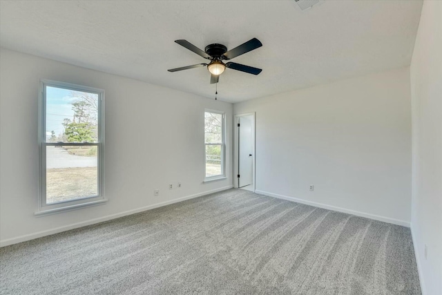 carpeted empty room with baseboards and ceiling fan