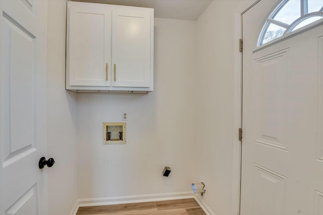 laundry room with cabinet space, hookup for a washing machine, baseboards, and light wood-style floors