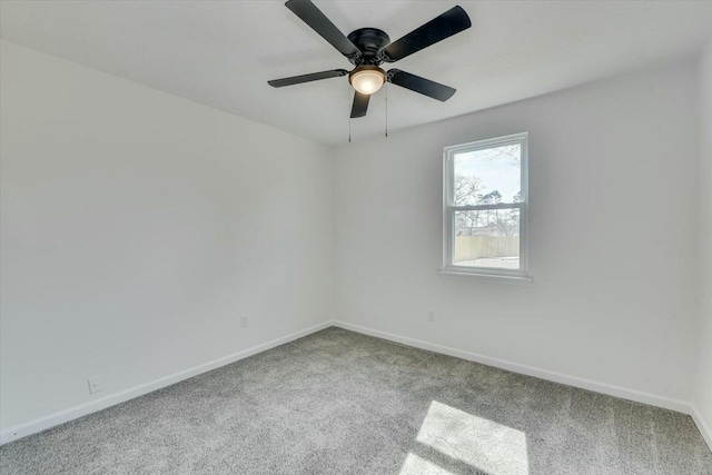 spare room featuring a ceiling fan, baseboards, and carpet floors