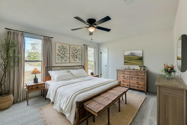 bedroom featuring light colored carpet, visible vents, and ceiling fan