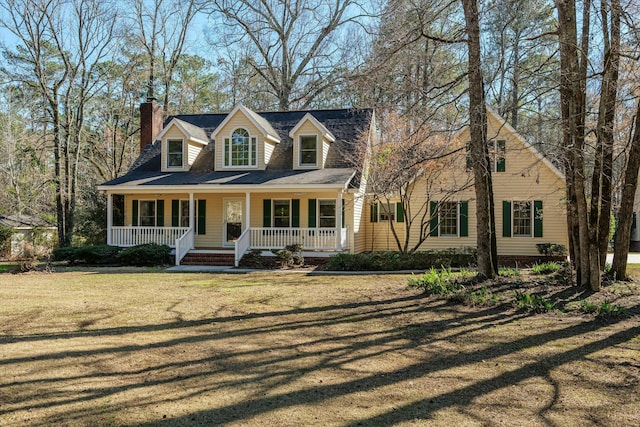 cape cod-style house featuring a front lawn and a porch