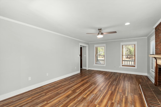 unfurnished living room with a fireplace, dark wood-type flooring, ornamental molding, and ceiling fan