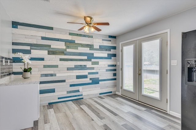 522 Gray Dr, Martinez, GA 30907 - entryway with french doors, wood walls, a ceiling fan, light wood-type flooring, and baseboards