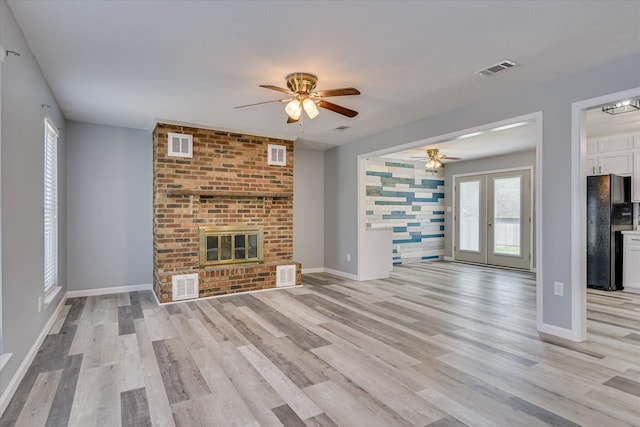 522 Gray Dr, Martinez, GA 30907 - unfurnished living room featuring a ceiling fan, light wood-type flooring, french doors, a fireplace, and baseboards