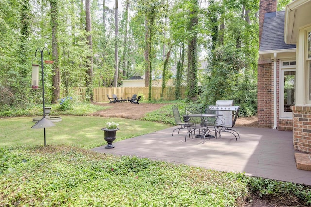view of yard featuring a deck and outdoor dining area