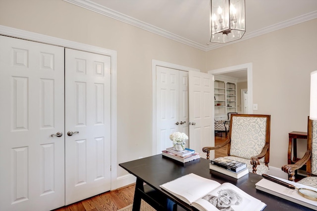 home office with a chandelier, wood finished floors, ornamental molding, and baseboards
