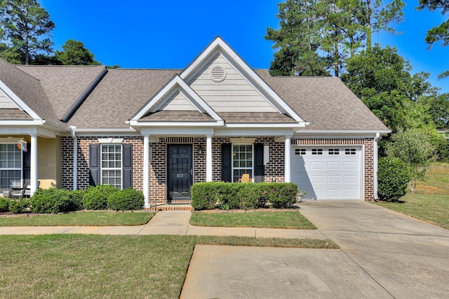 view of front of house with a front yard and a garage