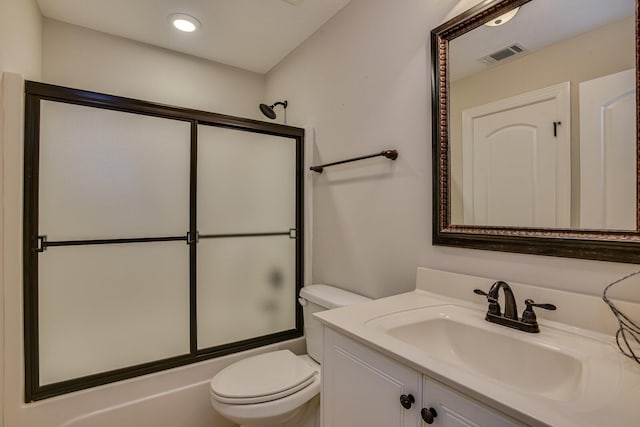 full bathroom with vanity, toilet, and combined bath / shower with glass door