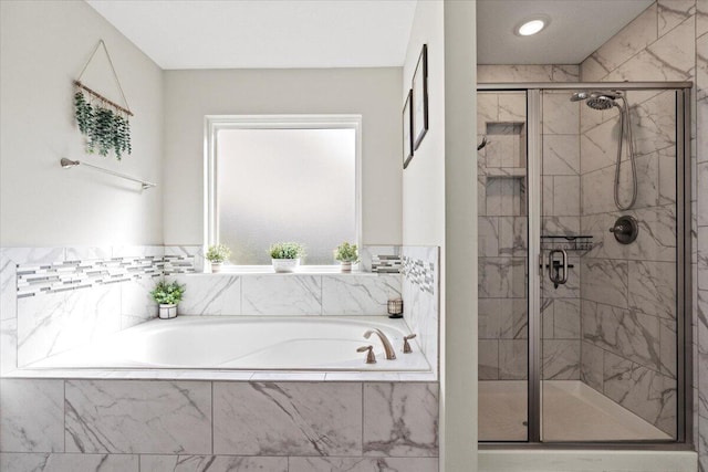 full bathroom featuring a bath and a shower stall