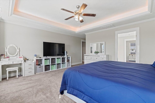 bedroom featuring ceiling fan, a raised ceiling, carpet floors, and ornamental molding