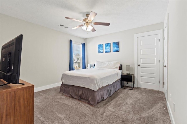 carpeted bedroom with visible vents, ceiling fan, a textured ceiling, and baseboards