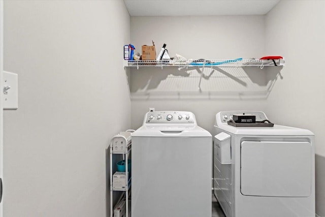 laundry room with laundry area and washing machine and clothes dryer