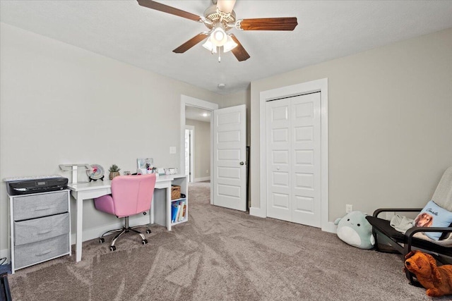 office space featuring baseboards, carpet, and a ceiling fan