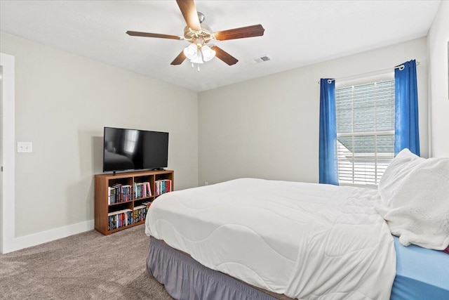 bedroom featuring visible vents, a ceiling fan, baseboards, and carpet floors