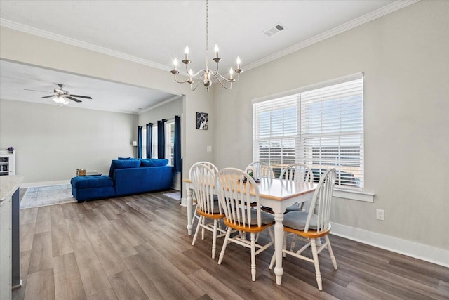 dining space with ornamental molding, wood finished floors, visible vents, and baseboards