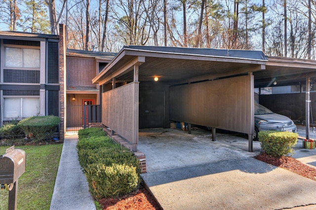 view of side of home with a carport