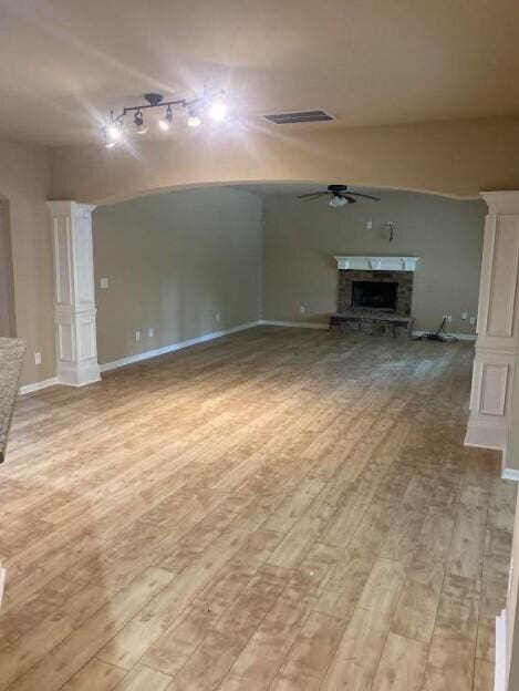 6066 Reynolds Cir, Grovetown, GA 30813 - unfurnished living room featuring ceiling fan, rail lighting, light wood-type flooring, and a fireplace
