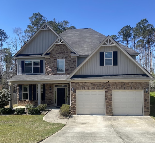 6066 Reynolds Cir, Grovetown, GA 30813 - view of front facade featuring board and batten siding, stone siding, driveway, and a porch