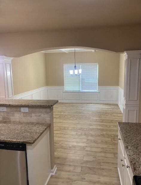 6066 Reynolds Cir, Grovetown, GA 30813 - kitchen featuring stainless steel dishwasher, light wood finished floors, white cabinets, a chandelier, and a decorative wall