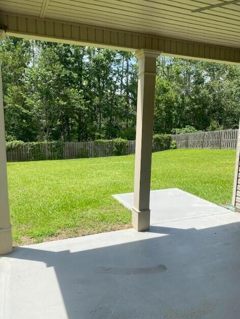 6066 Reynolds Cir, Grovetown, GA 30813 - fenced backyard with a patio area and view of scattered trees
