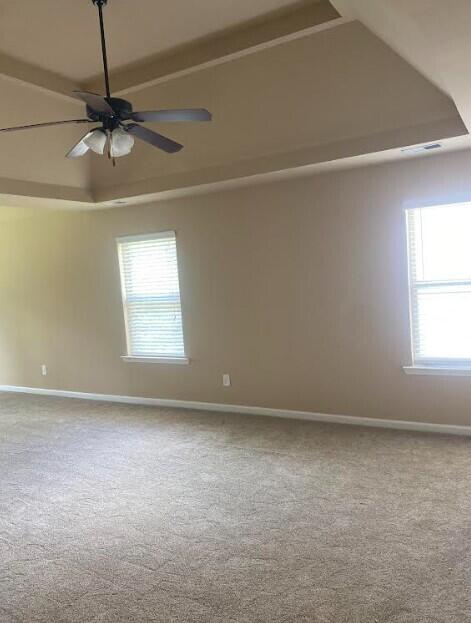 6066 Reynolds Cir, Grovetown, GA 30813 - carpeted spare room featuring healthy amount of natural light, ceiling fan, a raised ceiling, and vaulted ceiling