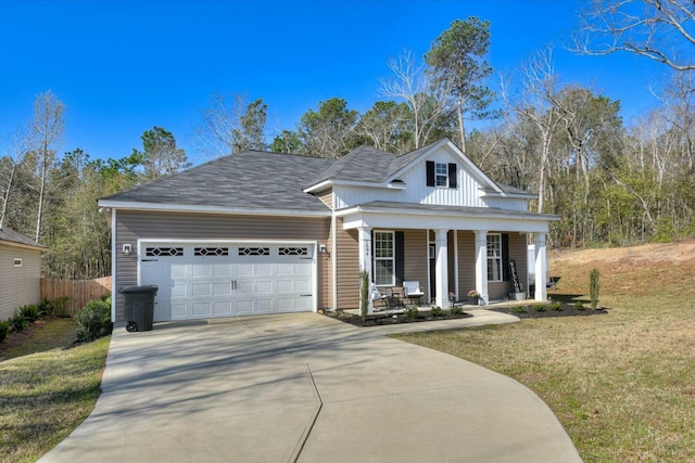 view of front of home featuring driveway, a front yard, a porch, and an attached garage