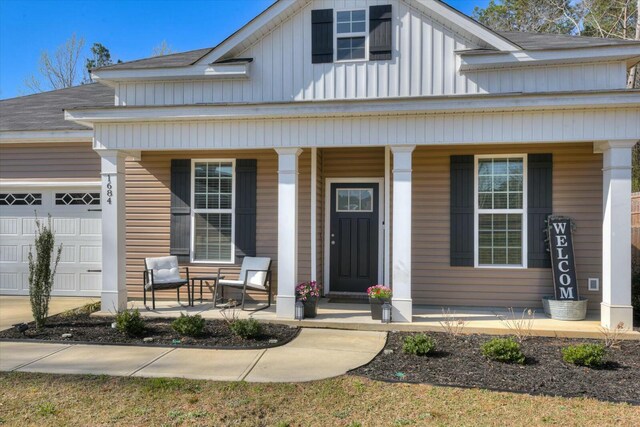 view of front facade featuring board and batten siding, a porch, a garage, and a shingled roof