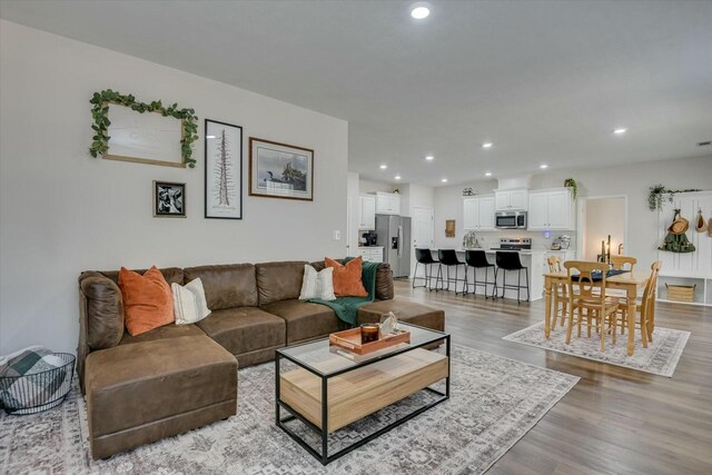 living room featuring recessed lighting and light wood-style floors