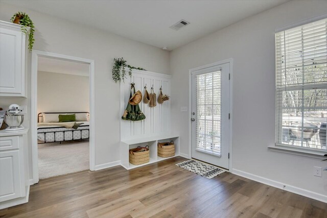 interior space with visible vents, baseboards, and wood finished floors