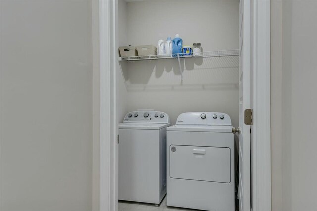 clothes washing area featuring washer and dryer