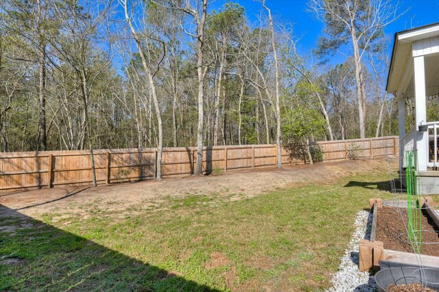 view of yard featuring a vegetable garden and a fenced backyard