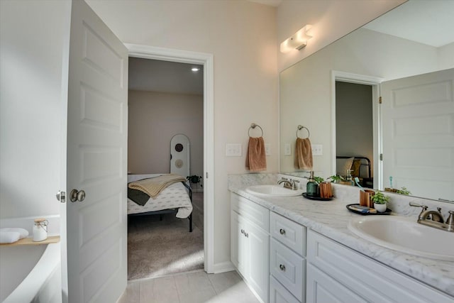 ensuite bathroom featuring a sink, ensuite bath, and double vanity